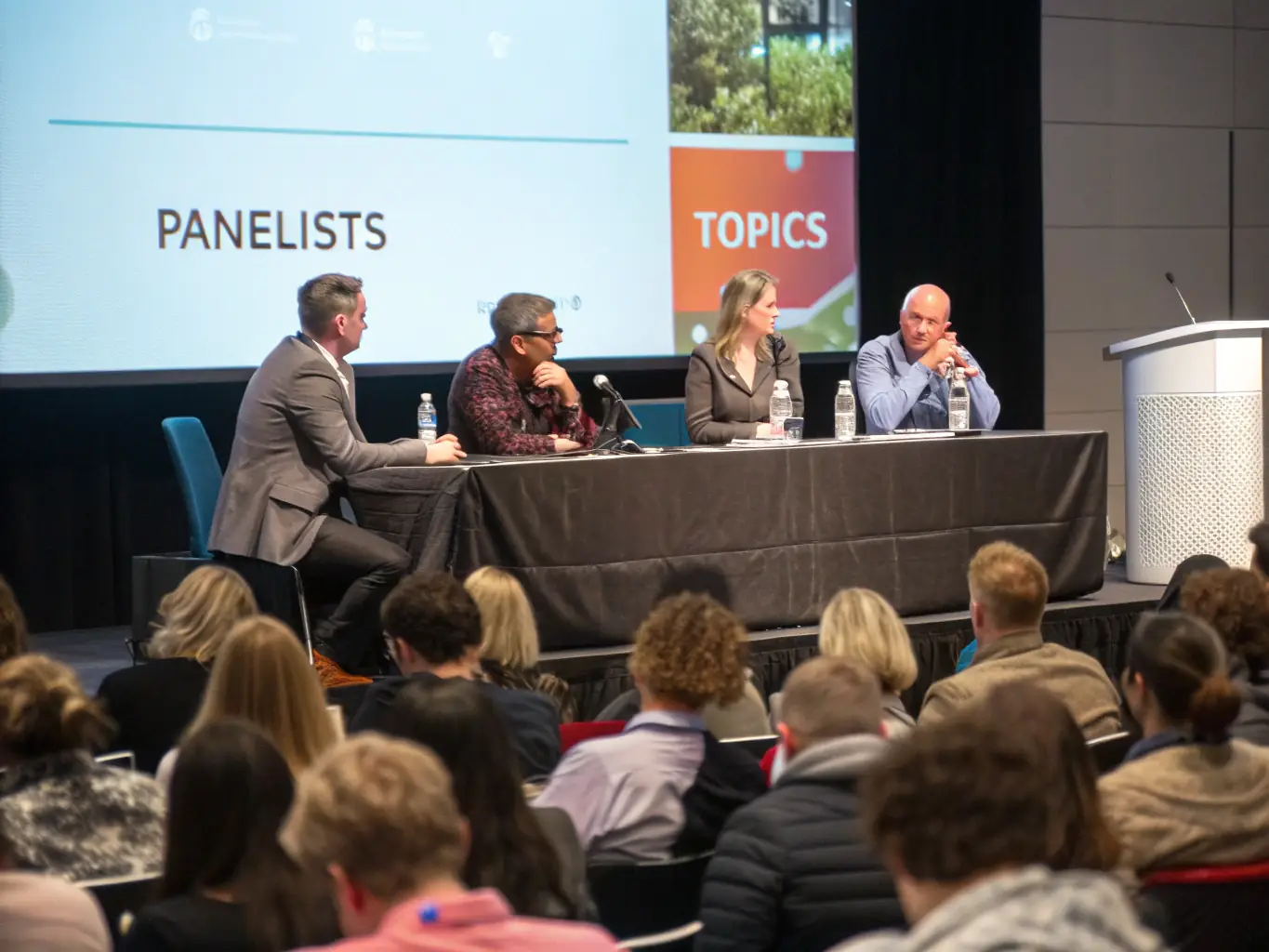 A photograph of a diverse group of professionals engaged in a panel discussion, highlighting the collaborative and insightful conversations at the MCP Summit.